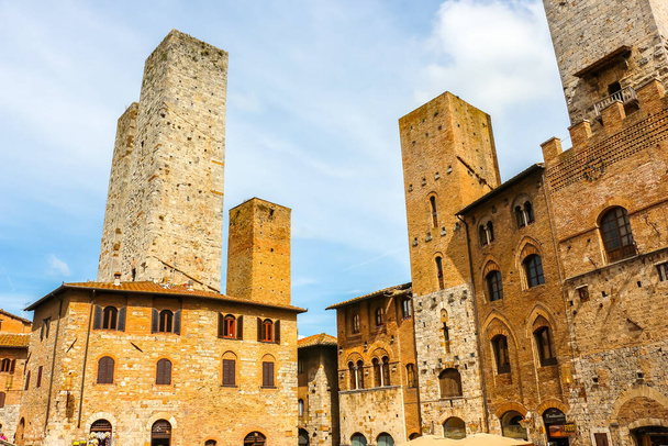 San Gimignano, Italy - Circa September 2018. View of medieval towers at the central square of San Gimignano. - Zdjęcie, obraz