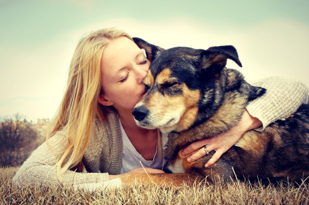 Woman Tenderly Hugging and Kissing Pet Dog - Photo, Image
