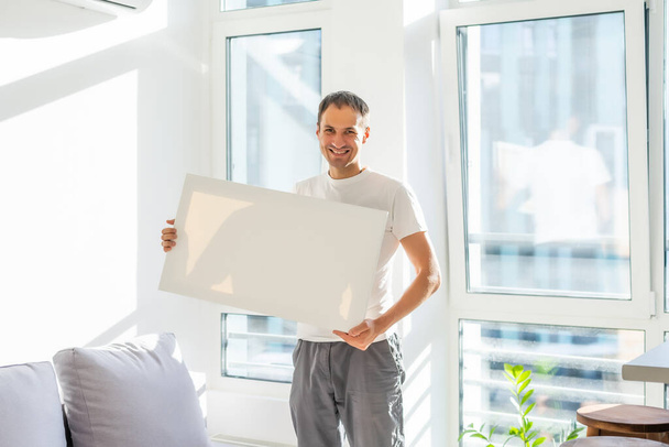 man with canvas mockup. Photo Mockup. The man hold canvas. For canvas design. - Fotoğraf, Görsel