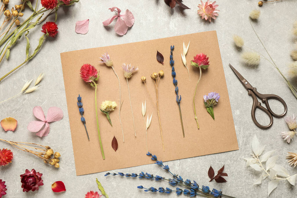 Flat lay composition with beautiful fresh and dry flowers on light grey background - Φωτογραφία, εικόνα