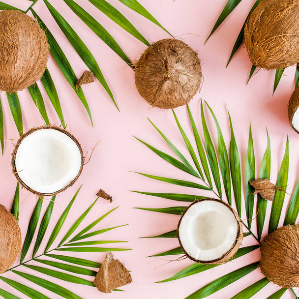 Pattern, texture with coconuts and tropical palm leaves on pink background. Tropical abstract background. Flat lay, top view. - Fotoğraf, Görsel
