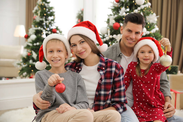 Happy family with cute children near Christmas tree together at home - Zdjęcie, obraz