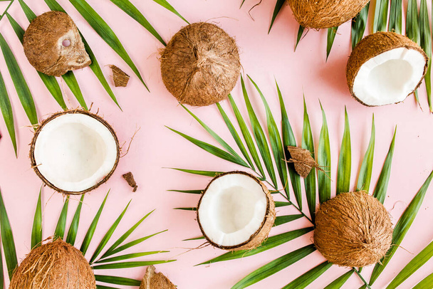 Pattern, texture with coconuts and tropical palm leaves on pink background. Tropical abstract background. Flat lay, top view. - Fotoğraf, Görsel