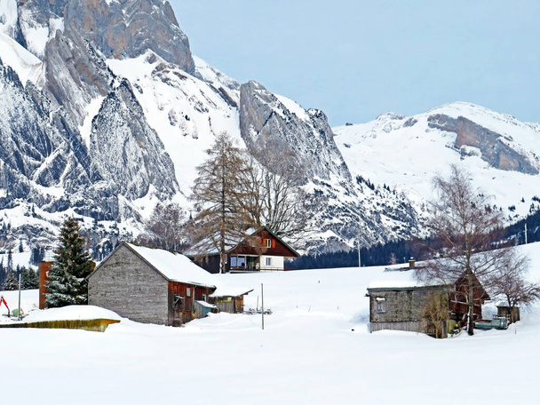 Idyllic Swiss alpine mountain huts and traditional Swiss rural architecture dressed in winter clothes and in a fresh snow cover in the Obertoggenburg region, Wildhaus - Canton of St. Gallen, Switzerland (Schweiz) - Foto, immagini