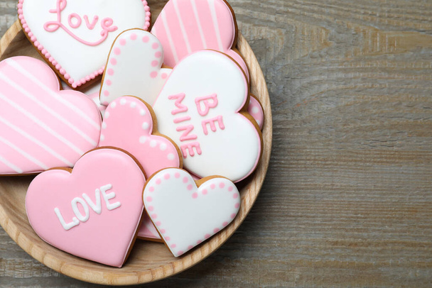 Valentine's day cookies in bowl on wooden table, top view. Space for text - Fotó, kép