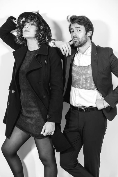 A Caucasian loving couple in a black and white fashion shoot, in elegant outfits - Zdjęcie, obraz