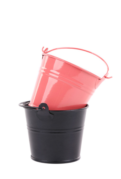 Black and pink metal buckets. - Foto, afbeelding