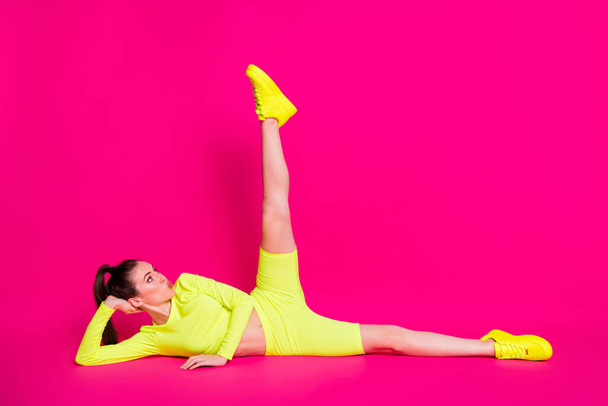 Full length body size photo of girl doing stretching sending air kiss with pouted lips isolated on vibrant pink color background - Fotó, kép