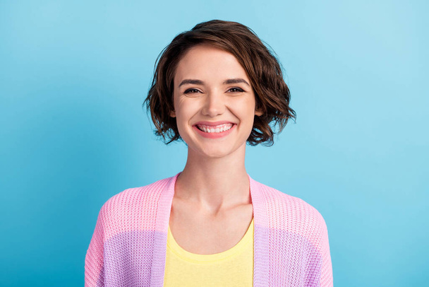 Close-up portrait of charming glad cheerful brown-haired girl wearing knitted blouse isolated over bright blue color background - Fotoğraf, Görsel