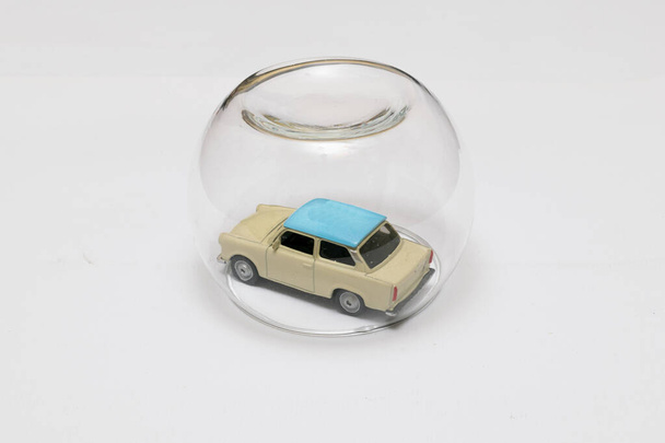 Toy car protected by translucent glass bubble in the center of box - 写真・画像