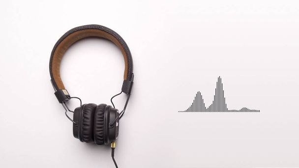 Full size headphones isolated on white background with moving equalizer graphs and glitch effect, seamless loop. Animation. Concept of electronic music. - Photo, Image