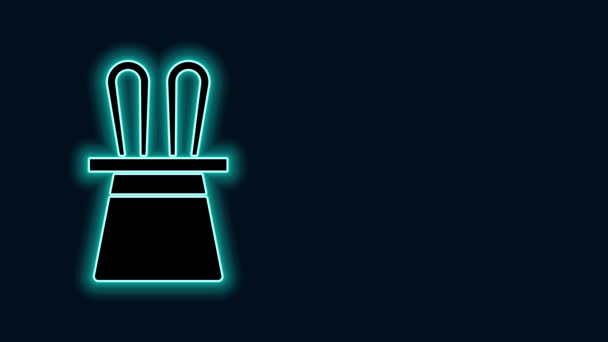 Glowing neon line Magician hat and rabbit ears icon isolated on black background. Magic trick. Mystery entertainment concept. 4K Video motion graphic animation - Footage, Video