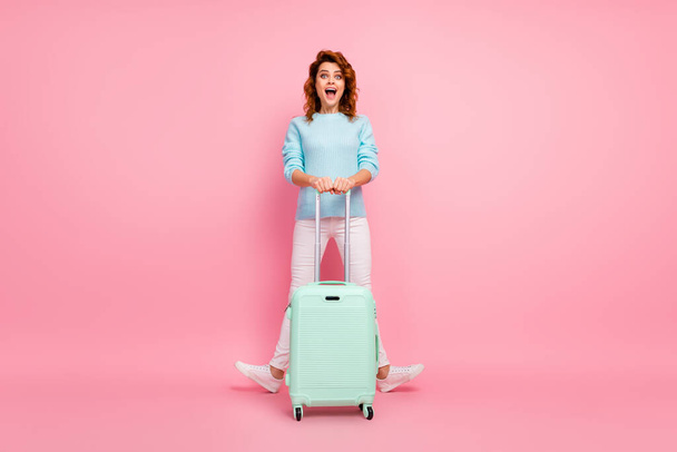 Full length body size view of her she nice-looking attractive lovely pretty glad cheerful cheery wavy-haired girl carrying luggage having fun isolated over pink pastel color background - Foto, Imagem