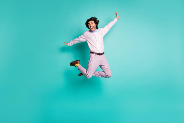 Full body photo of happy crazy gentleman jump dressed formal outfit yellow socks isolated on turquoise color background - Zdjęcie, obraz