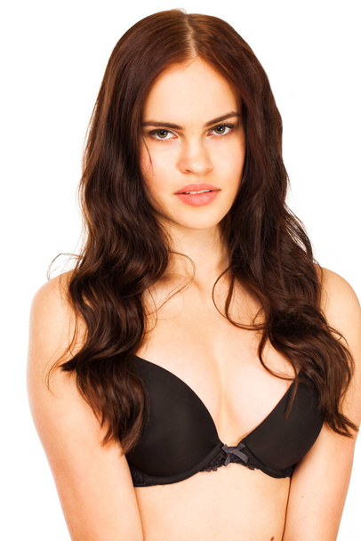 Young sexy brunette woman in black bra, isolated on white background - Valokuva, kuva