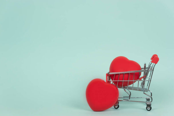 A shopping trolley with red hearts in it. Copy space. Healthcare concept - Photo, Image