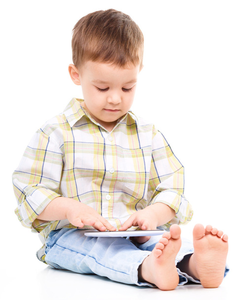 Young boy is using tablet - Фото, изображение