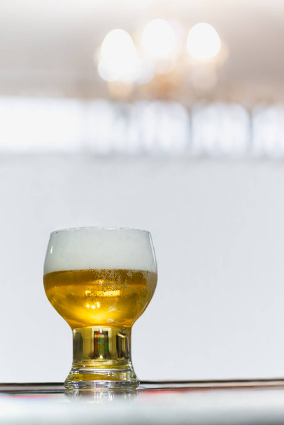 Glass of light beer on a dark pub. - Fotó, kép