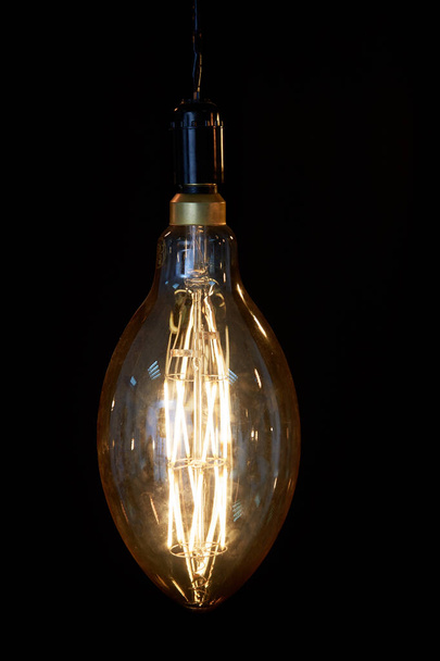 old vintage electric lamp on black background - Fotografie, Obrázek