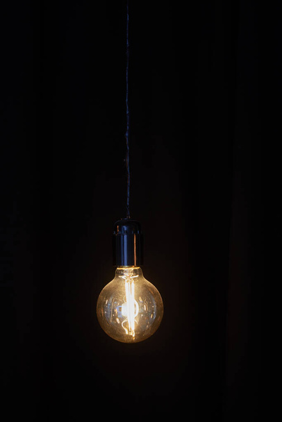 old vintage electric lamp on black background - Foto, Imagem