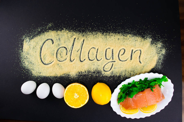 Set of products containing collagen, essential for youthful skin and healthy joints. The concept of proper nutrition. Lettering on gelatin. Black background. Flat lay, top view. Copy space. - Photo, Image