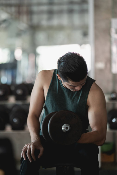 Close up of man using dumbbell exercise at gym, Sport concept - Fotografie, Obrázek
