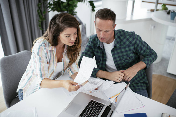 Husband and wife preparing bills to pay. Young couple having financial problems. - Photo, Image