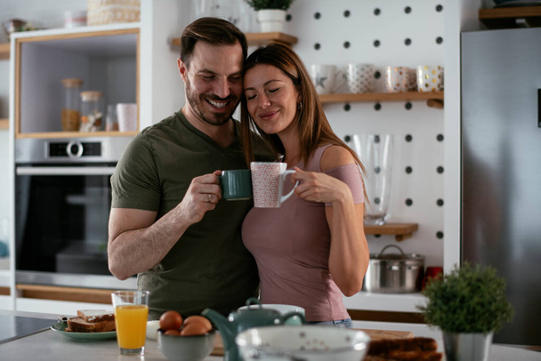 happy couple having breakfast in the kitchen  - Foto, immagini