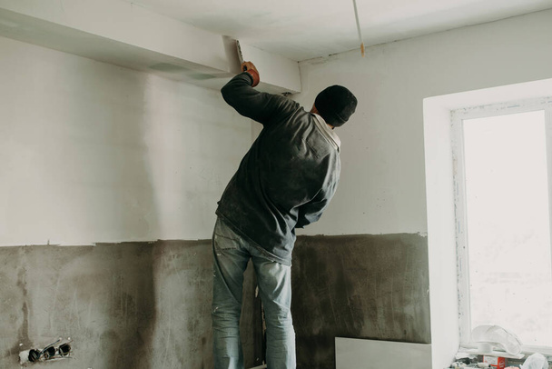 homem vidraceiro reparação teto em um apartamento - Foto, Imagem