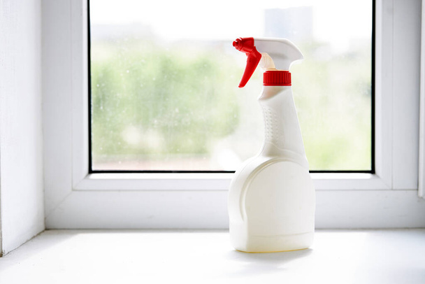 cleaning or washing dirty domestic window with a chemical spray. housework cleanup concept - Photo, Image