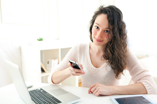 Portrait of young business woman writing a text on her mobile - Photo, Image