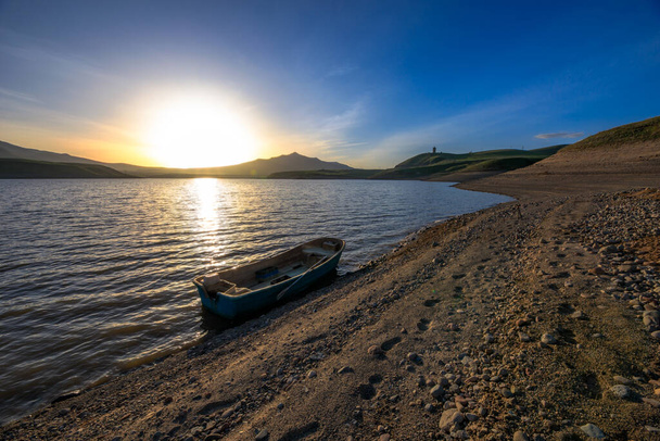 old boat in lake at the sunset backgroun - Zdjęcie, obraz