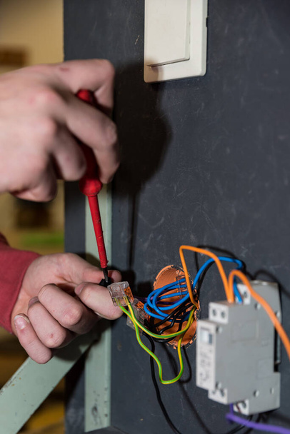 Elektroinženýr instaluje spínač, zásuvku a relé - detailní záběr - Fotografie, Obrázek