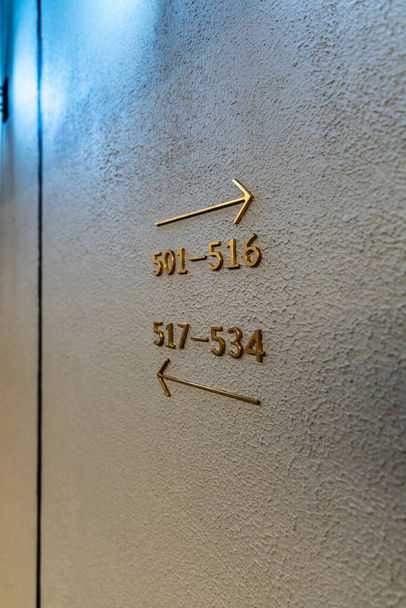 Blue painted wall with golden elements with arrows and numbers - Photo, Image