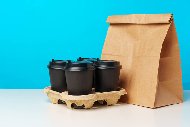 Coffee cups and takeaway food package. Takeout meal - Fotografie, Obrázek
