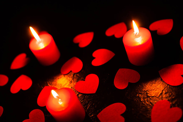 black background with candles and hearts on Valentines Day - Valokuva, kuva