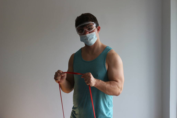 COVID fitness related photos. Man works out with mask  - Photo, Image