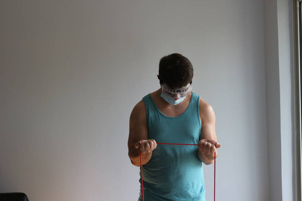 COVID fitness related photos. Man works out with mask  - Fotoğraf, Görsel
