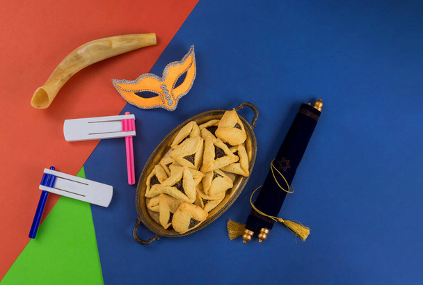 Purim Jewish holiday with hamantaschen cookies hamans ears, carnival mask and parchment - Photo, Image