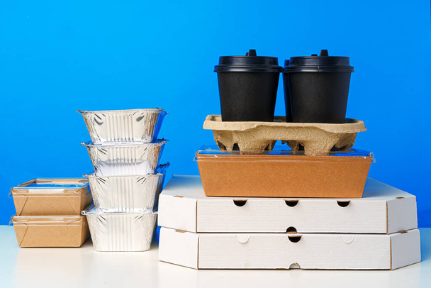 Assortment of various food delivery containers on table - Foto, Imagem