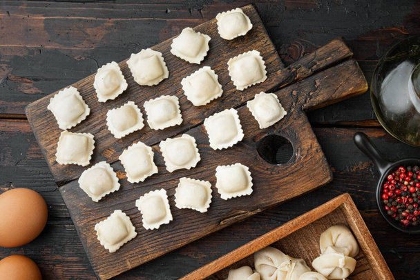 Italian Ravioli ingredients with fresh ricotta leaves and tomatoes set on old dark  wooden table background, top view flat lay - Photo, Image