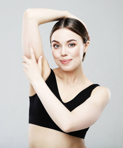 Young woman showing armpit with smooth clean skin on white background, closeup over white background - Фото, зображення