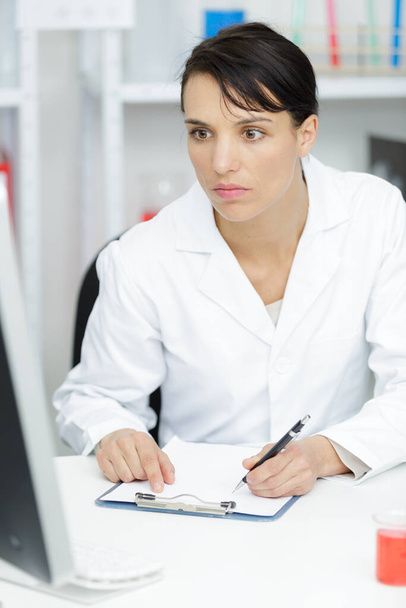 portrait of serious female doctor working in lab - Zdjęcie, obraz