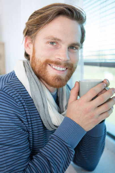 successful man drinking coffee next to window - Foto, Imagen