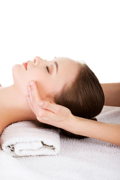 Relaxed woman enjoy receiving face massage - Фото, изображение