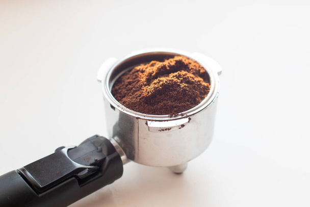 Coffee holder with ground coffee on white background - Fotó, kép