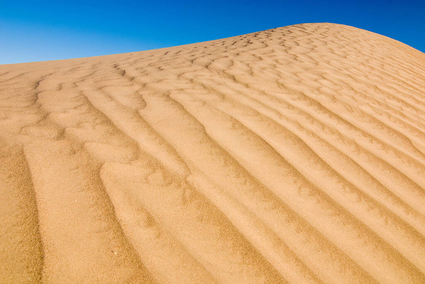 A closeup shot of a sand wave texture in the desert. Beautiful wallpaper - Фото, изображение