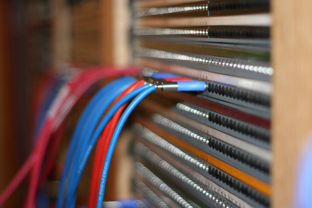 A closeup shot of colorful connected electric cables on a blurred background - Φωτογραφία, εικόνα