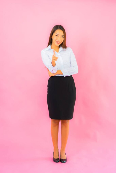Portrait beautiful young business asian woman with action pink isolated background - Fotoğraf, Görsel