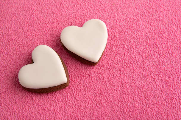 Biscotti a forma di cuore bianco su sfondo rosa. Festa della mamma. Festa della donna. San Valentino. - Foto, immagini